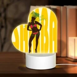 Love Acrylic Night Light, A Woman Wearing A Grass Skirt And A Head Dress Stands In Front Of A Yellow Background.