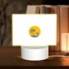 Rectangular Acrylic Night Light, A Yellow Sun With Two Palm Trees In The Middle Of A White Background.
