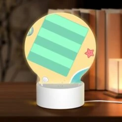 Round Acrylic Night Light, A Cartoon Beach Scene With A Striped Beach Towel