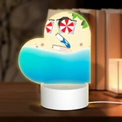 Love Acrylic Night Light, A Red And White Umbrella Is Laying On The Beach.