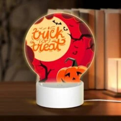 Round Acrylic Night Light, A Halloween Themed Poster With A Pumpkin And A Spider Web.