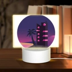 Rectangular Acrylic Night Light, A Tall Building With A Pink And Black Color Scheme Is Lit Up At Night.